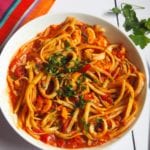 Spicy Seafood Pasta | This Spicy Seafood Pasta is packed full of flavour with juicy prawns and calamari in a rich tomato sauce with a kick of chilli and chopped basil. Gluten and dairy free too.